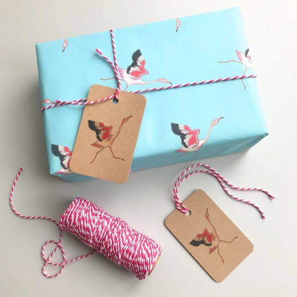 A close-up photo of a gift box containing a flamingo figurine.