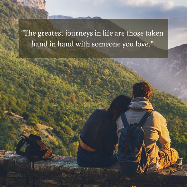 Couple sitting together overlooking a mountainous landscape with an inspirational travel quote.