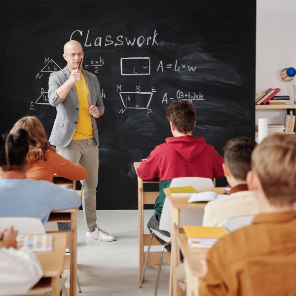 A teacher engaging a classroom, perfect for an article with a witty caption about educators.