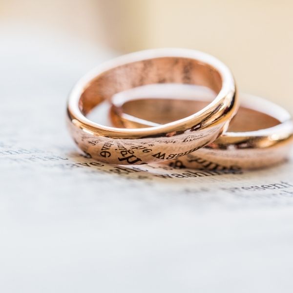 Close-up of bronze wedding rings, symbolizing the traditional 8th-anniversary gift, for a happy 8th anniversary.