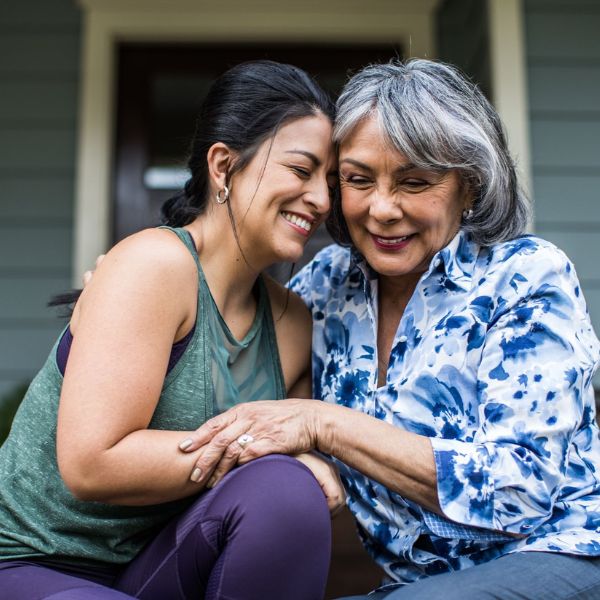 A radiant mother and daughter laughing together, symbolizing the special bond and shared memories between them.