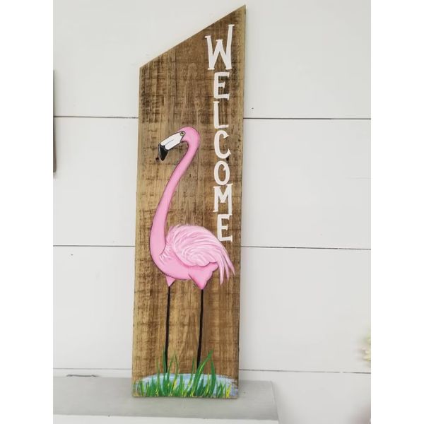 Wood Flamingo Welcome Sign greets guests with a warm tropical welcome.