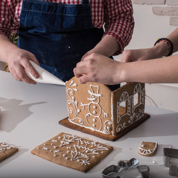 Decorate a gingerbread house, a delightful holiday-themed activity and a cute romantic date idea.