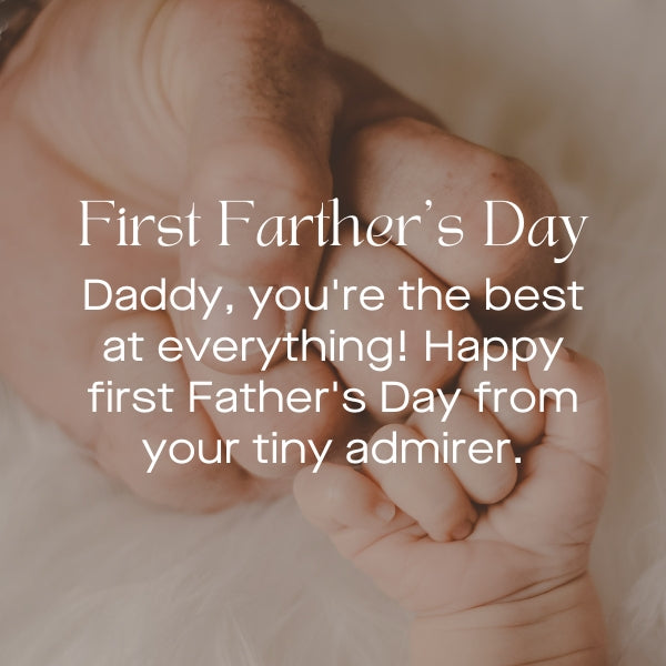 Newborn's hand holding a father's finger with a Happy First Father's Day greeting from a tiny admirer.