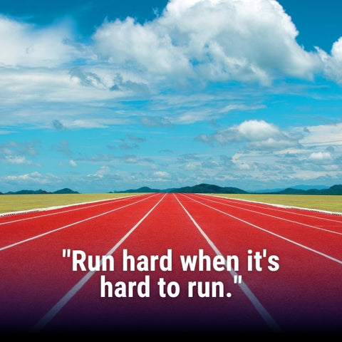 An athlete running on a track captures the competitive spirit of motivational running quotes.