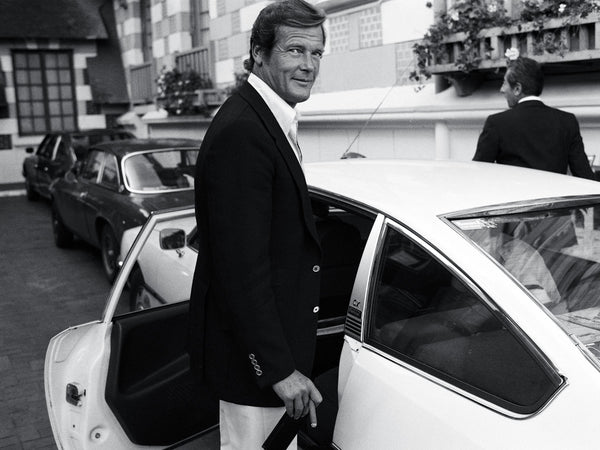 007 james bond roger moore getting into a car