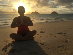 Jenny Jean Almquist meditating on Lanikai Beach