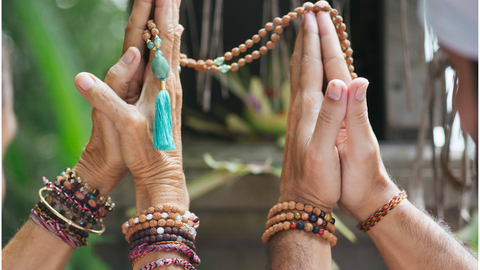 Hands using Bali Malas rudraksha prayer beads