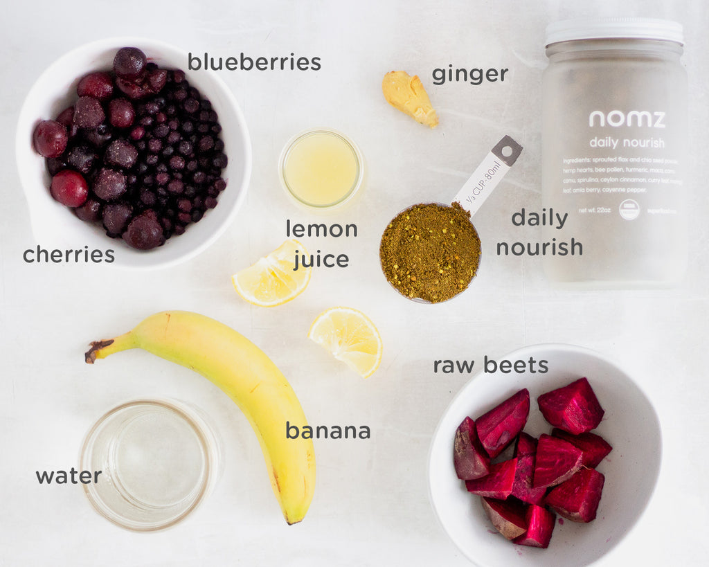 ingredients for berry beet smoothie from overhead on concrete surface