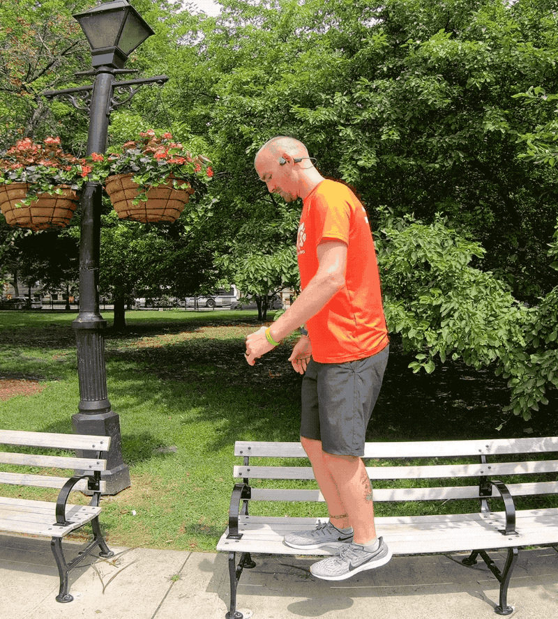 Man stepping of bench with one leg