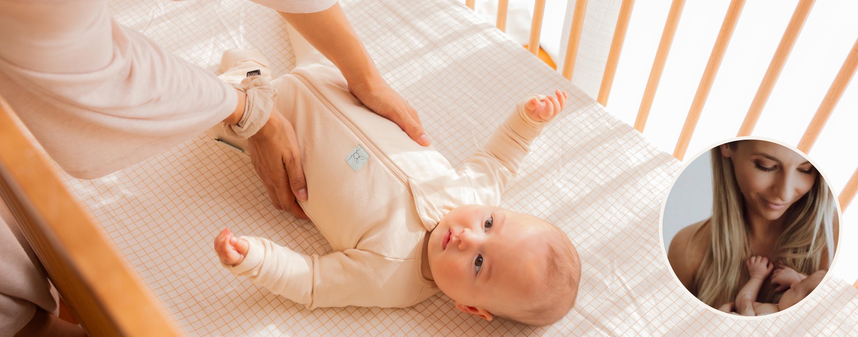 A parent places their baby in the Lyra Convertible Cot