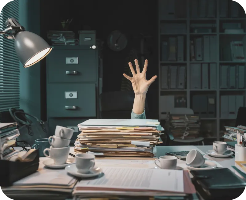 Person overwhelmed with paperwork reaching out