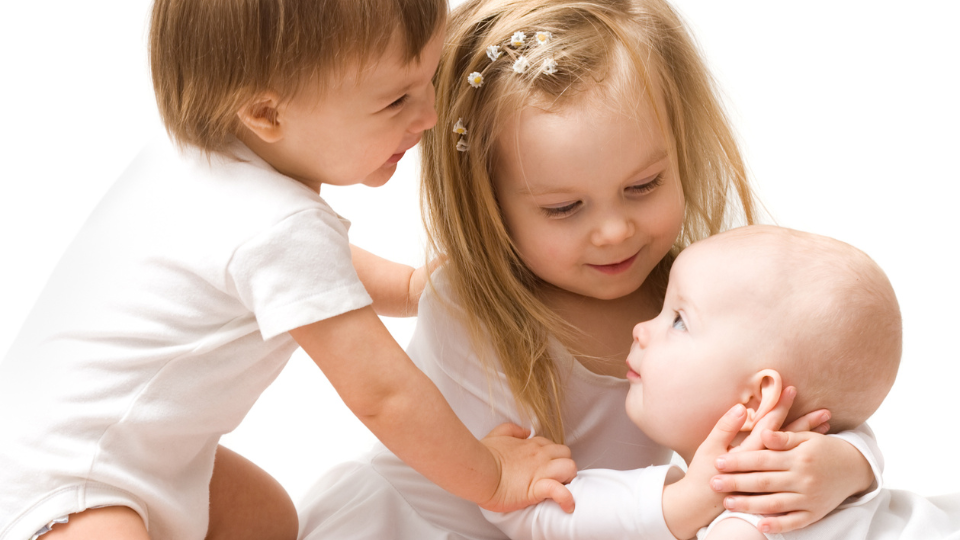 Two babies sitting back to back | Safe Sleep Space