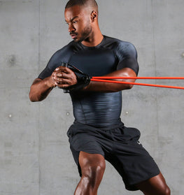 man doing excercise with power resitance bands