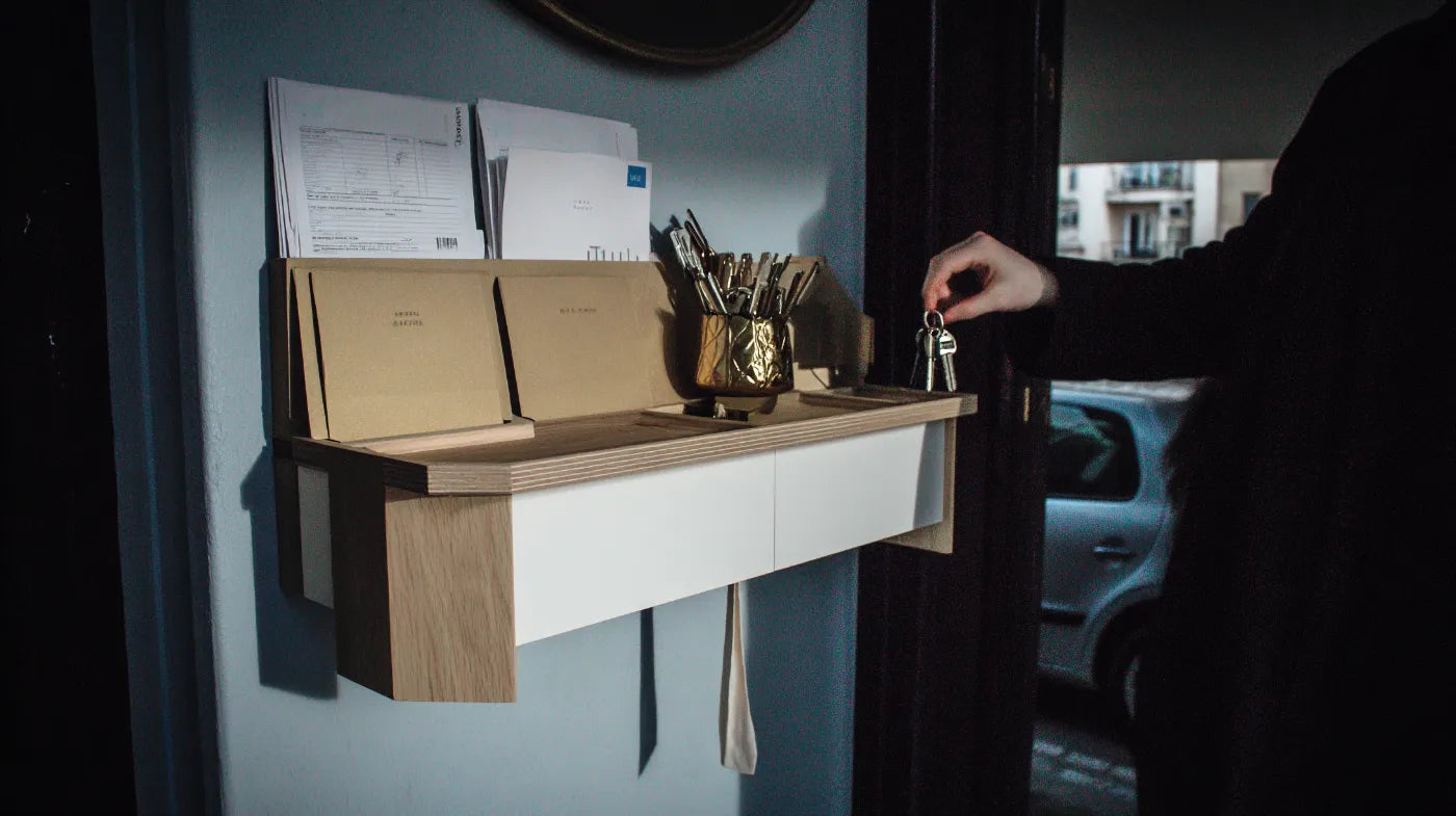 A British hallway console table with labelled trays for keys, post, and accessories, creating clear homes for everyday essentials.