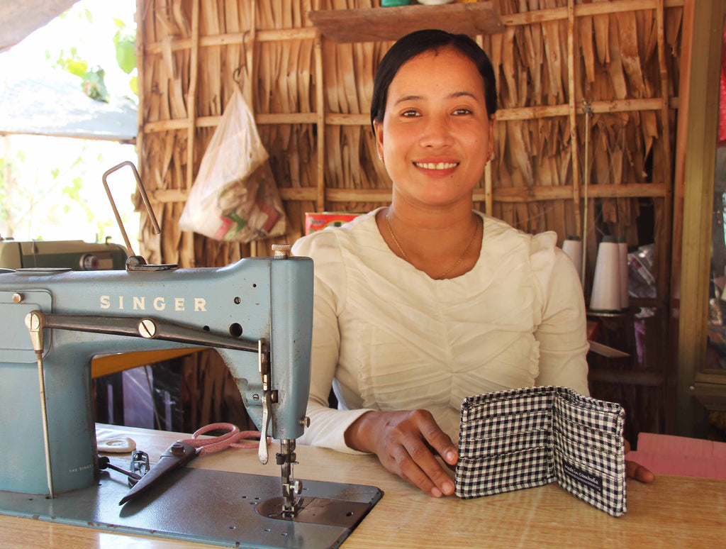 Saney with Human and Hope Association’s men’s wallet. These wallets are available to purchase on the Temples and Markets website.