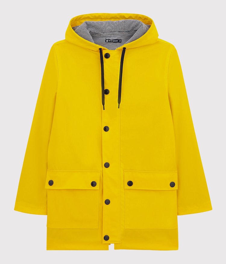 yellow raincoat small boat