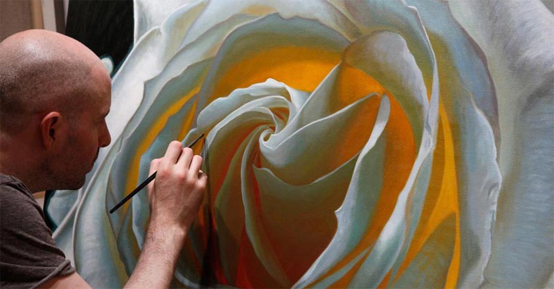 Vincent Keeling painting a large rose in oil on canvas
