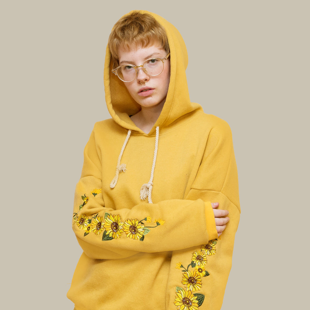 yellow hoodie with sunflowers on sleeves