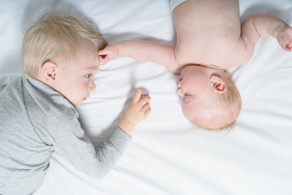 Bog brother playing with baby