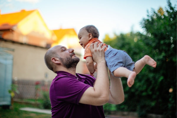 Daddy playing with baby