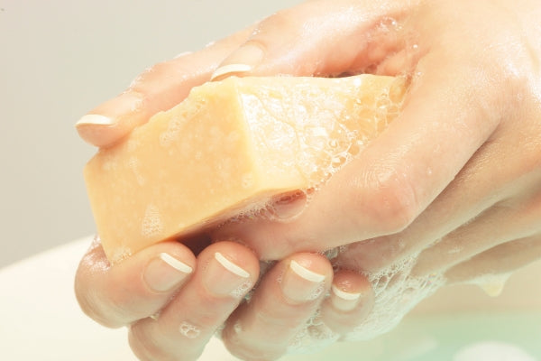 hands holding lathering soap