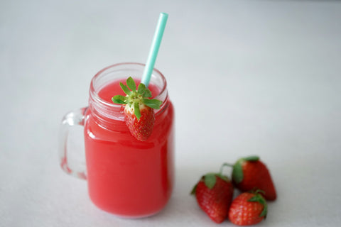 a-small-plastic-cup-strawberry-juice