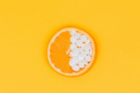 pills-orange-fruit-slices-on-yellow-surface