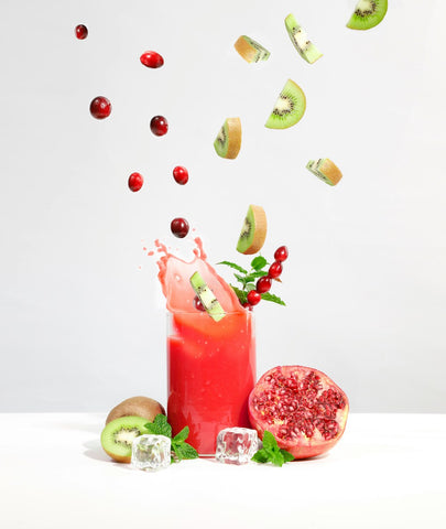 strawberry-juice-in-clear-drinking-glass-kiwi-cherries-falling-inside