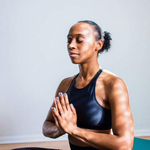 woman-doing-yoga-wearing-black-sports-bra