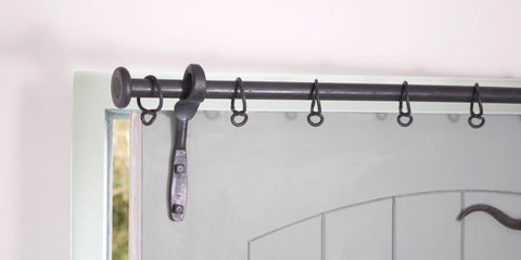 Wrought iron drapery arm door bracket