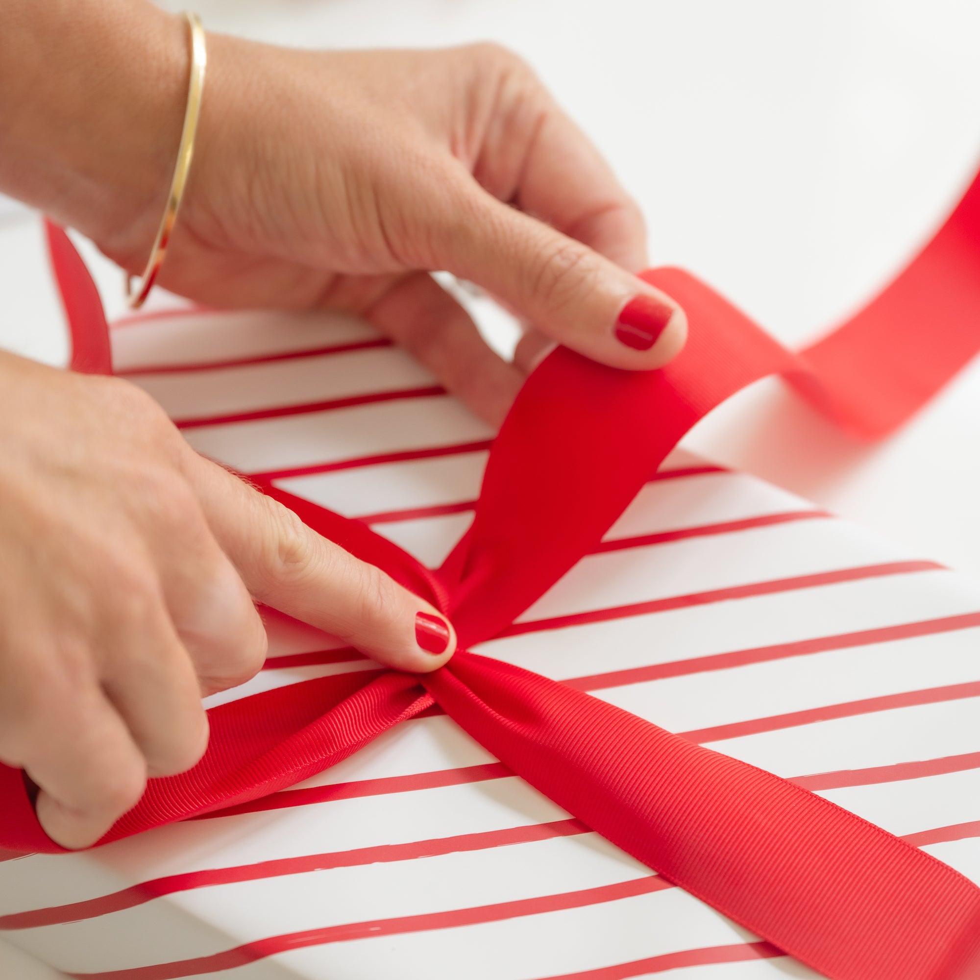 Ribbon being tied around gift