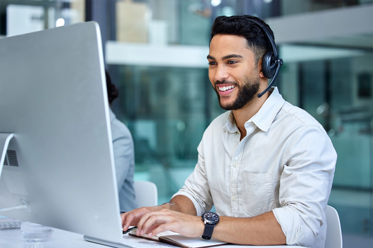 man on the phone whilst on the computer