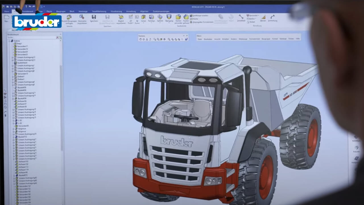 Bruder engineer works on designing a toy truck with CAD software.