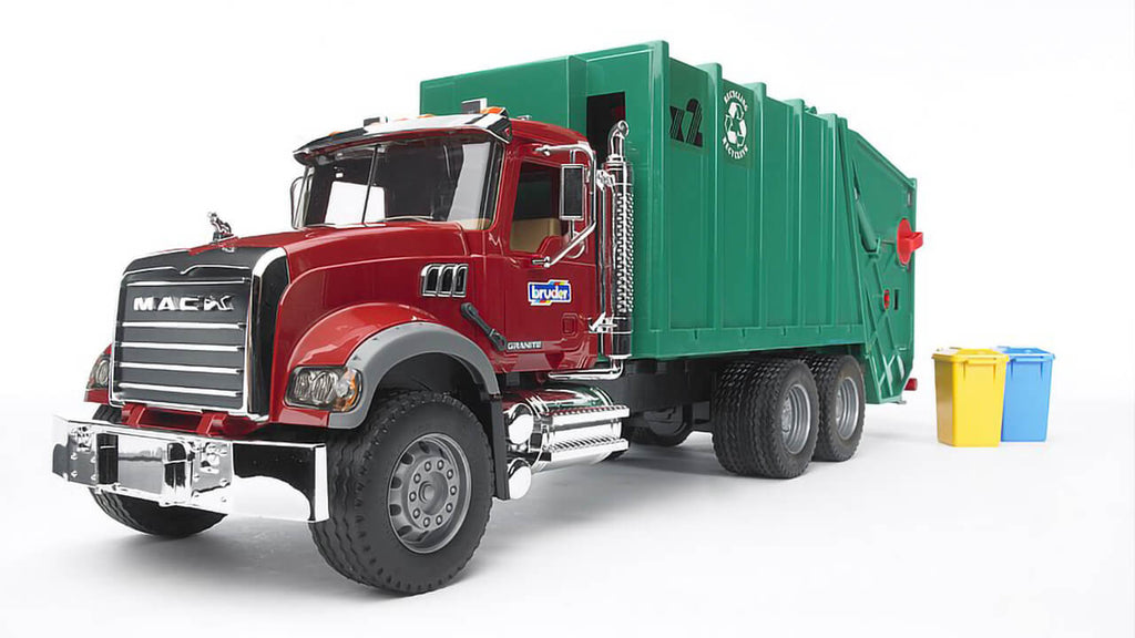 Front quarter view of the Bruder MACK Granite Rear Loading Garbage Truck. The truck is red and the container is green.