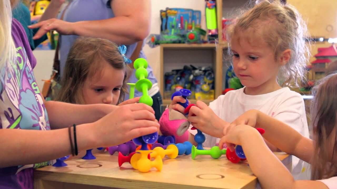 Kids building with Squigz from Fat Brain Toys