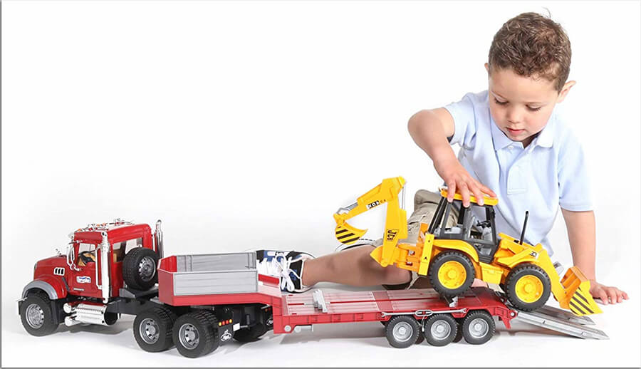 Boy playing with large 1:16 scale Bruder Toy.