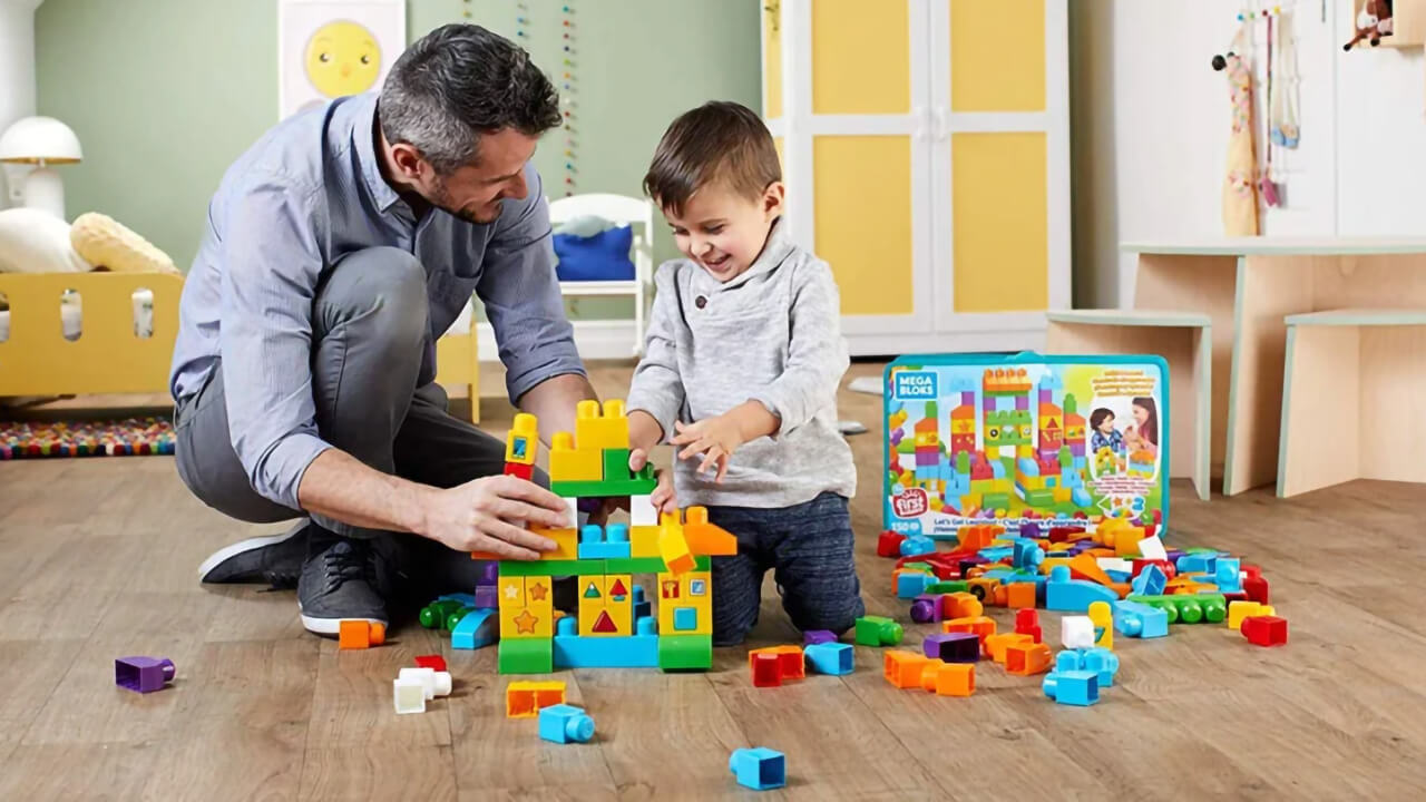 Father and son play with Mega Bloks.