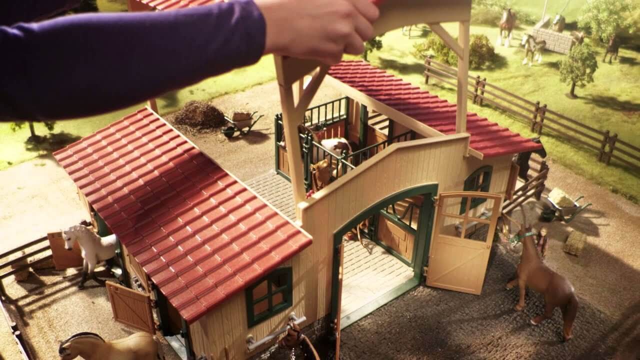 Schleich horse sets being set up in a setting with horses and custom pieces.