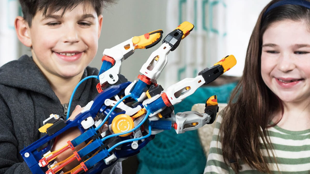 Boy and girl playing with the Thames & Kosmos Megahand STEM Building Kit