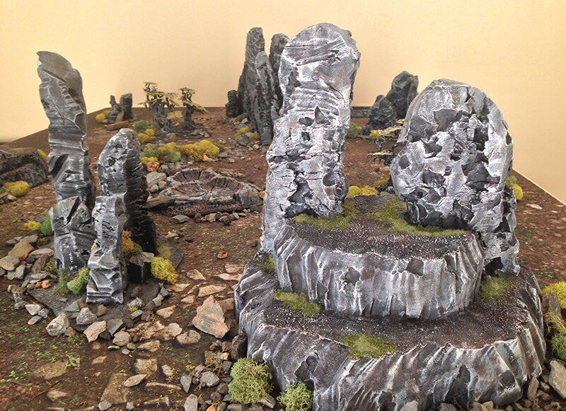 Warhammer terrain example with multiple levels of grass and rocks.
