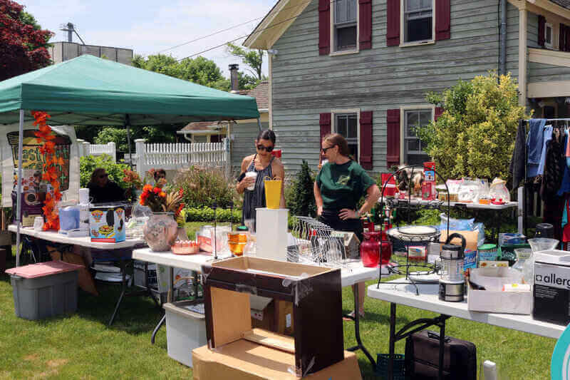 A family having a yard sale to sell toys.