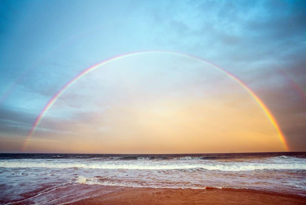 A double rainbow seen by the beach in the early morning