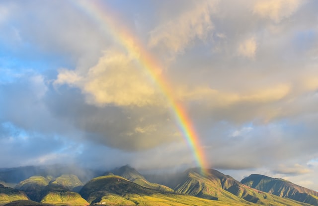 rainbows over green hills
