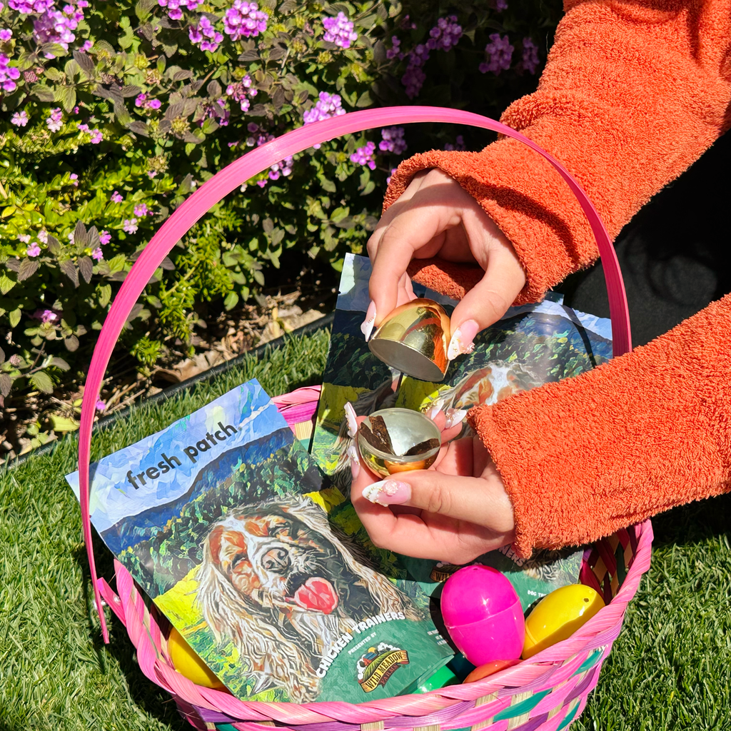 hand model opening easter egg with treats over easter basket