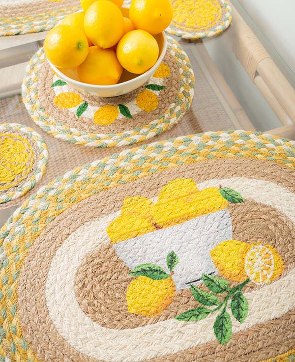 Oval placemat and trivet with lemon designs in yellow, tan and sage green braided jute colors