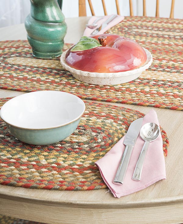 Braided placemat with orange, sage, yellow and tan colors