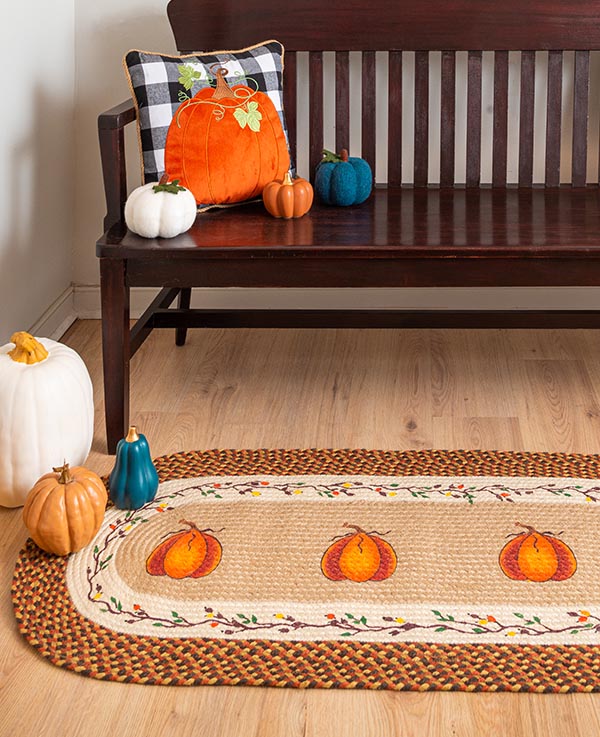 Runner rug with harvest pumpkin design and floral border