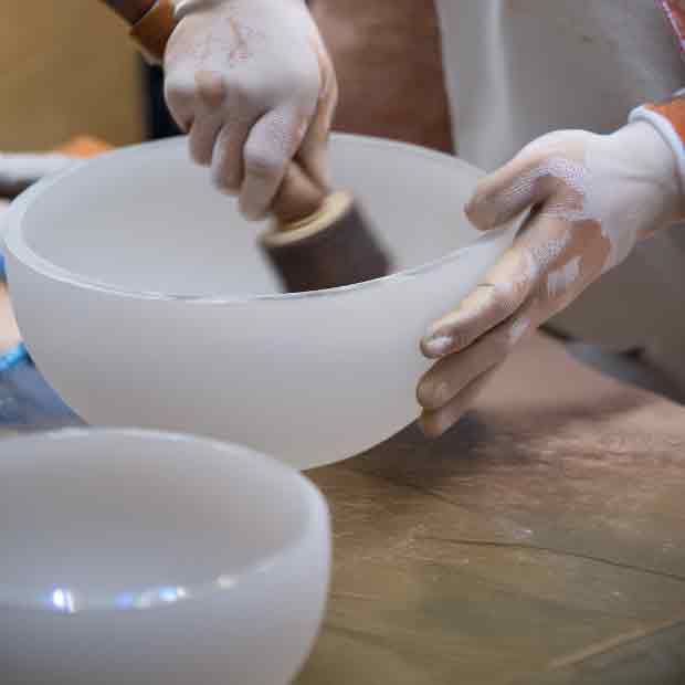 Skilled craftsman polishing a crystal singing bowl