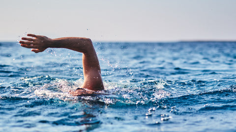 A person arm raised ocean swimming